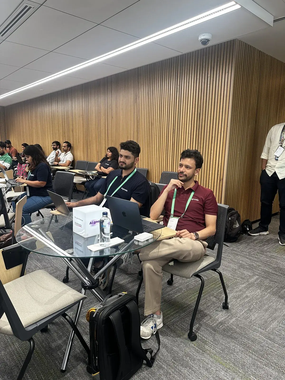Aignosis co-founders at a table during an event session